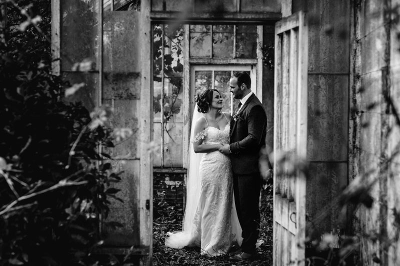 Sarah Bruce Photography Hooton Pagnell Hall Wedding day Portrait of bride and groom in derelict greenhouse